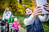 Man taking a photo of family