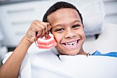 Boy holding model teeth
