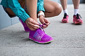 Woman tying laces on trainers