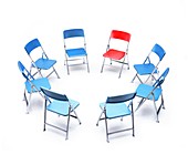 Circle of blue chairs with one red chair