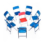 Circle of chairs with one in the middle