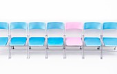One pink chair in a row of blue chairs