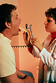 Doctor examining AIDS patient