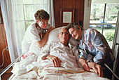 Old-age care: nurse with elderly couple in home