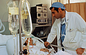 Doctor attending patient in intensive care unit