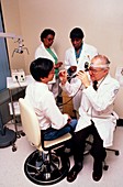 Tinnitus clinic: doctor using otoscope