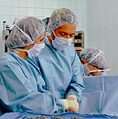 Nurse and surgeon in operating theatre