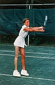 Woman with artificial leg playing tennis