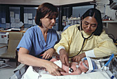 Doctor Examines Premature Baby