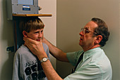 Boy being measured after growth hormone therapy