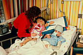 Nurse comforting sick child in U.S. hospital