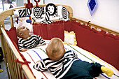 Infant in crib with mobile