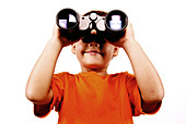 5-year old boy looking through binoculars