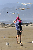 Father and Daughter Feeding Gulls