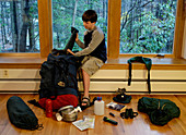 Boy packing camping gear for a trip