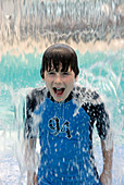Boy getting soaked in summertime