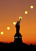 Sun Rising behind Statue of Liberty