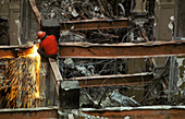 Construction worker demolishing a building