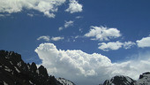 Cumulus clouds over mountains, timelapse