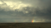 Mammatus clouds and rainbow