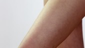 Woman rubbing thigh