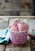Strawberry ice cream with colourful sprinkles