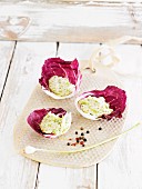 Cashew nut cream with young garlic in radicchio leaves