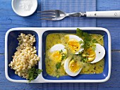Eggs in curry and mustard sauce with wheat and fresh chervil