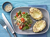 Avocado with an almond crust served with bulgar wheat and tomato salad