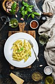 Penne with pesto sauce and fresh basil, Parmesan cheese and spices