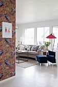 Peacock-patterned wallpaper in bright vintage living room