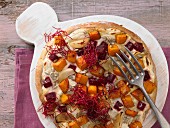 A pizza with beetroot and pumpkin