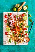 A salad with grilled chicken, honey and lime
