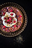 Fig upside-down cake with raspberries, pistachio nuts, cream, yoghurt and honey