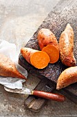 Sweet potatoes on a rustic wooden board