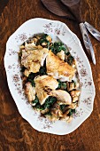 Sliced roast chicken with kale (seen from above)