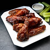 Smoked chicken wings with ranch dressing and celery