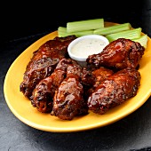 Smoked chicken wings with ranch dressing and celary