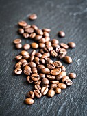 Coffee beans on a dark slate surface
