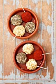 Goats' cheese balls coated in paprika powder, walnuts and dried herbs