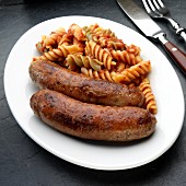 Two Italian sausages (salsiccia) with pasta tricolore