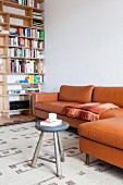 Comfortable leather couch next to bookcase