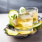 A cocktail with limes and ice cubes