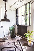 Vintage workbench and industrial windows in workshop