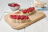 Raspberry jam on two slices of ciabatta bread