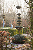 Topiary and clipped hedges in wintry garden