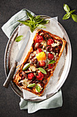 A breakfast pastry with tomatoes, mushrooms and chorizo