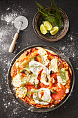 A breakfast pizza with smoked trout, poached egg and capers