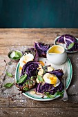 Fried red cabbage with parmesan, herb oil, poached eggs and chive hollandaise