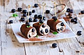 Chocolate pancake rolls with cream cheese and blueberries